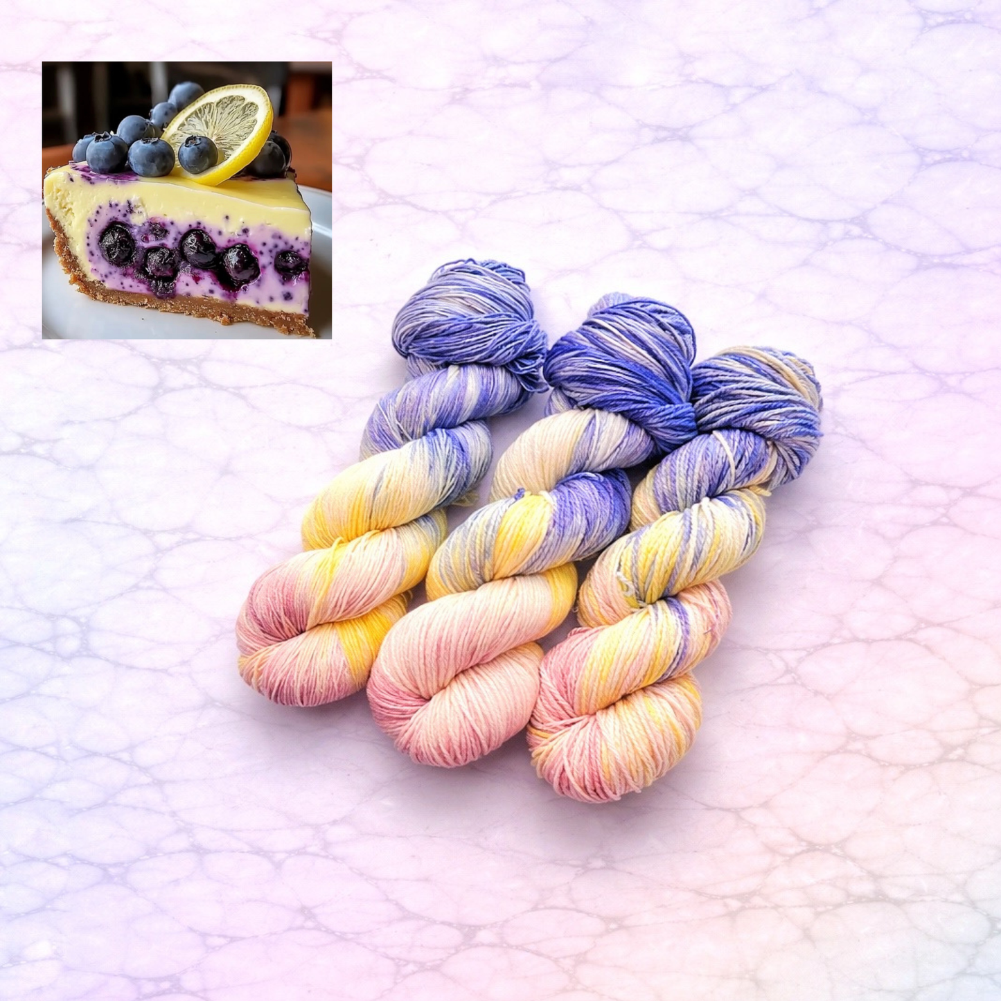 Pastel skeins of yarn on a textured surface with a small inset of blueberry cheesecake.